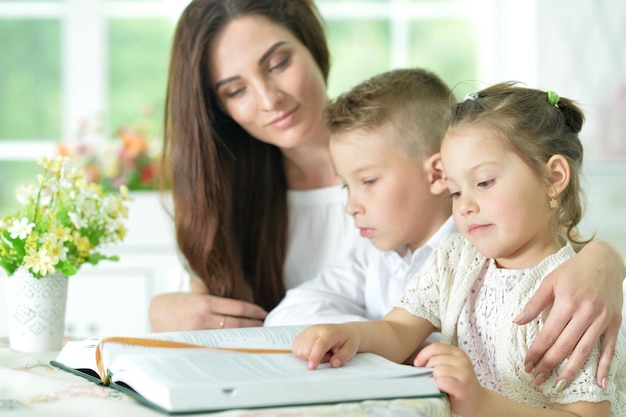 Mother and children reading book