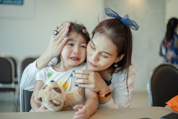 Mother comforting crying daughter with family problem concept