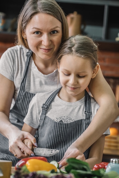 Mother cooking with daughter in the kitchen