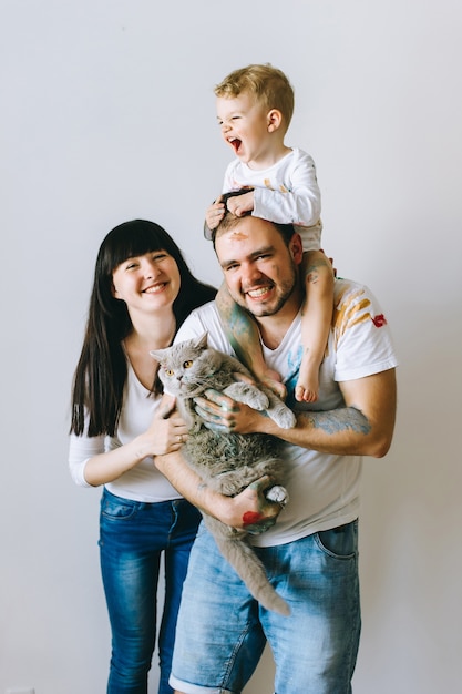 mother dad son and cat on a white background after playing paint