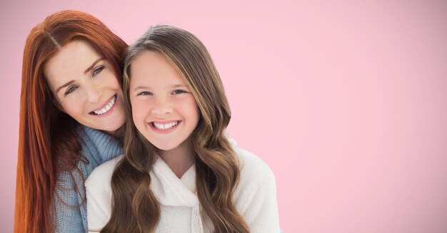 Mother and daughter against pink background