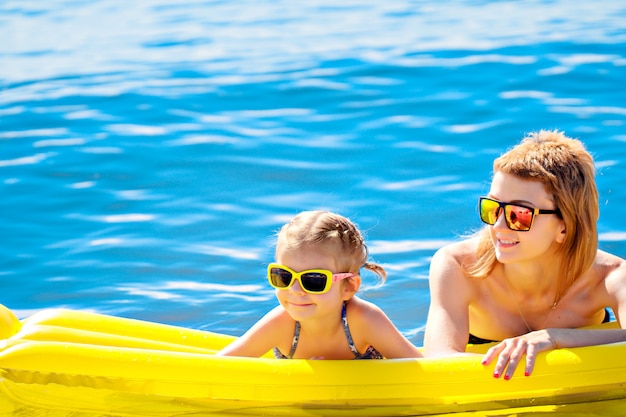 Mother and daughter on airbed