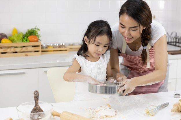 Mother and daughter are preparing the dough