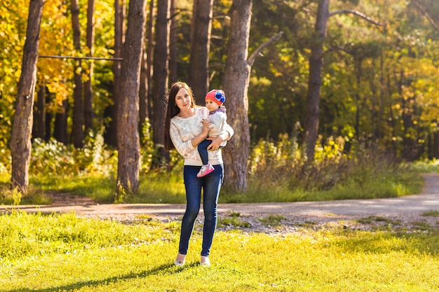 Mother and daughter in the autumn park