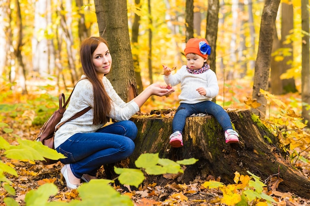 Mother and daughter in the autumn park