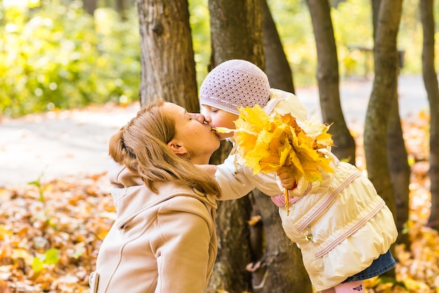 Mother and daughter in the autumn park