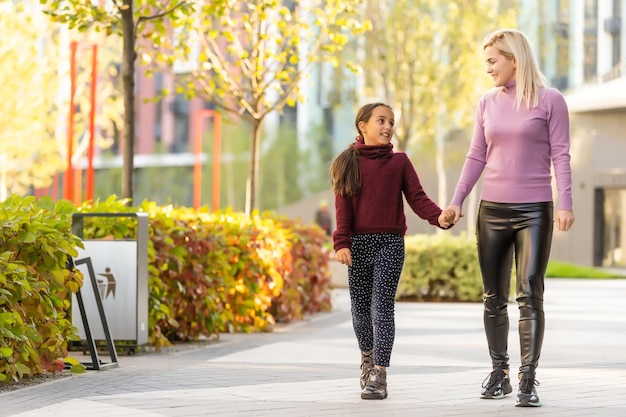 mother and daughter during autumn.