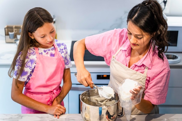 Mother and daughter baking delicious cakes at home