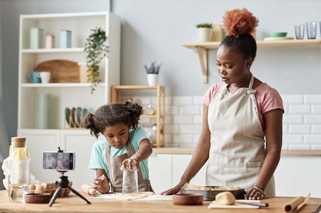 Mother and daughter baking together in kitchen