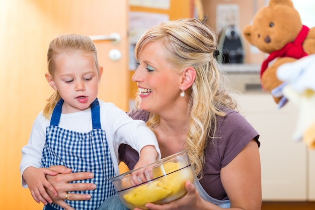 Mother and daughter baking together