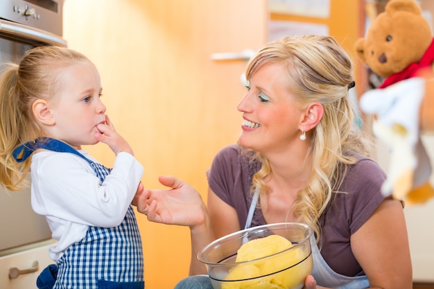 Mother and daughter baking together