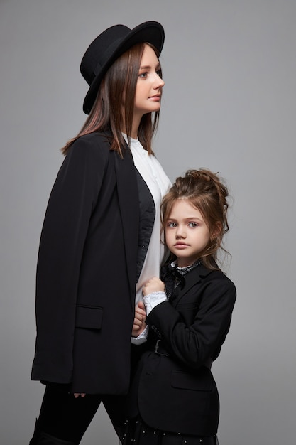 Mother and daughter in black coats