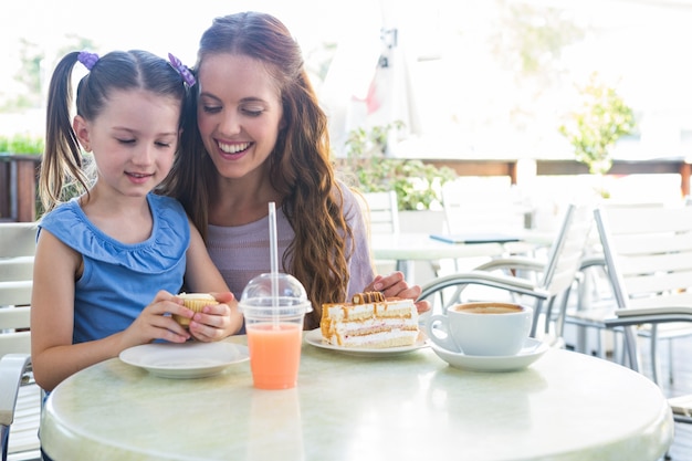 Mother and daughter at cafe terrace