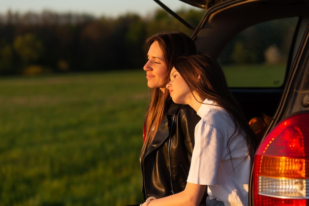 Mother and daughter camping on a hill