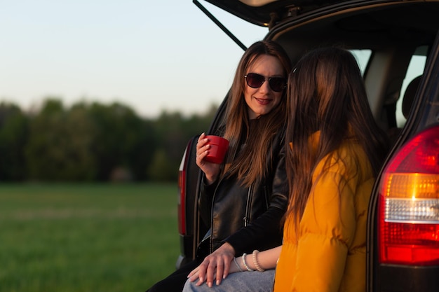 Mother and daughter camping on a hill