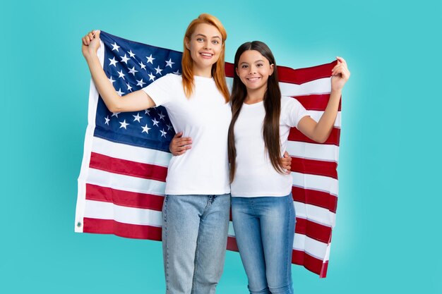 Mother and daughter child girl teenager with American flag USA celebrate 4th of July Independence Day Patriotic US holiday concept