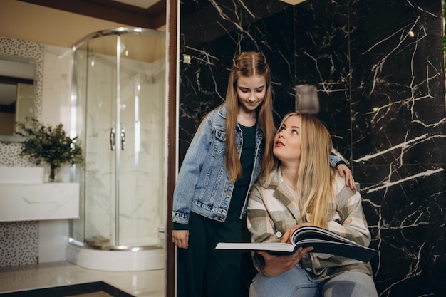 Mother and daughter choose tiles for the bathroom