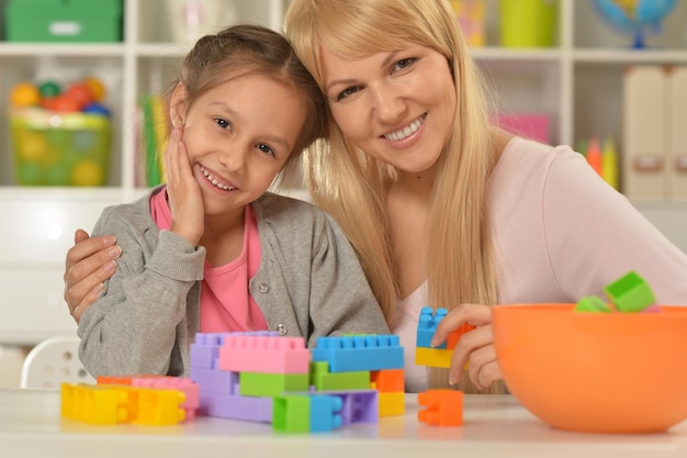Mother and daughter collecting blocks