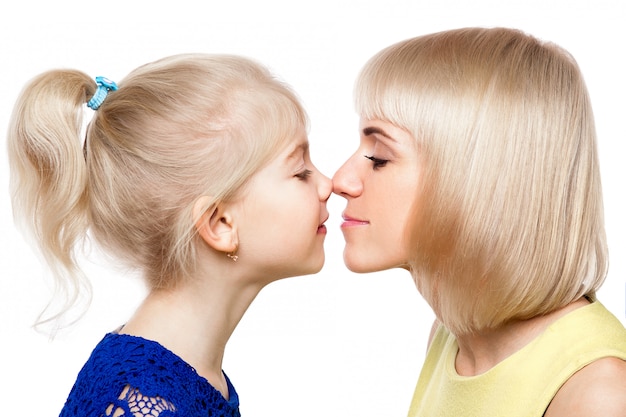 Mother and daughter in colorful dress on white background