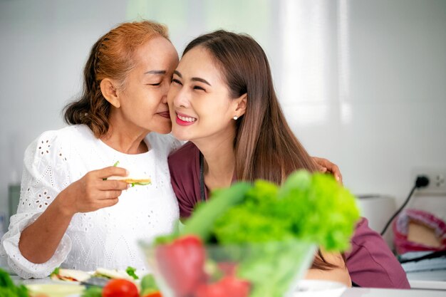 Mother and daughter cooking in the kitchen mother and daughter hugging to love on mother's day Asian family