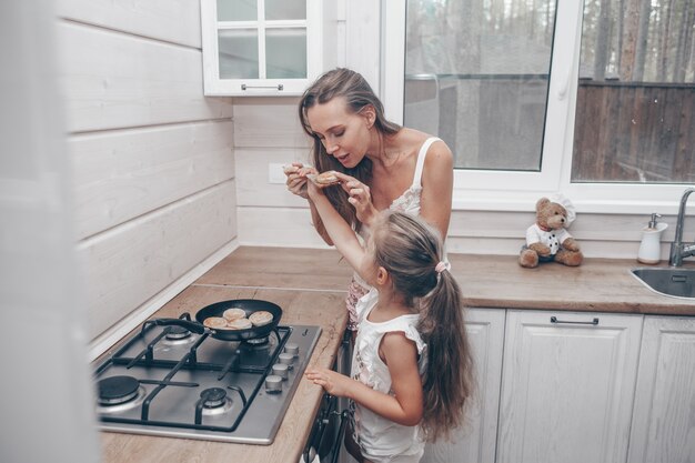 Mother and daughter cooking together in the kitchen