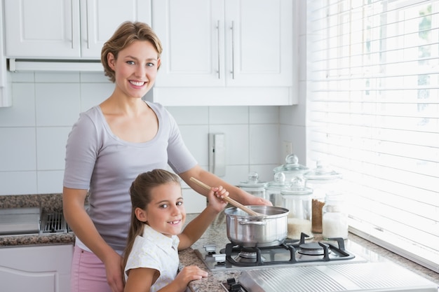 Mother and daughter cooking together