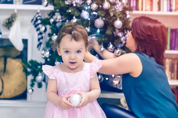 Mother and daughter decorating the Christmas tree