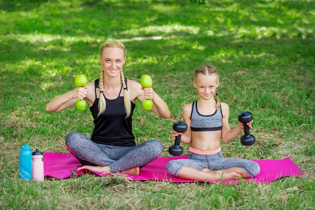 Mother and daughter doing gym exercises