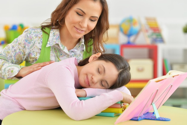 Mother and daughter doing their homework in the room