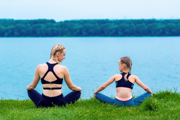 Mother and daughter doing yoga exercises