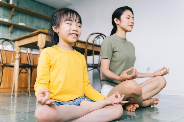 mother and daughter doing yoga at home