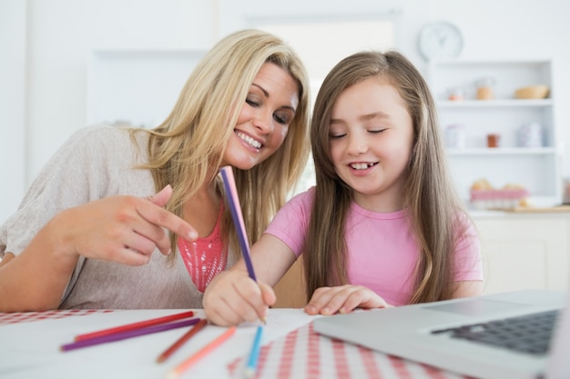 Mother and daughter drawing together 