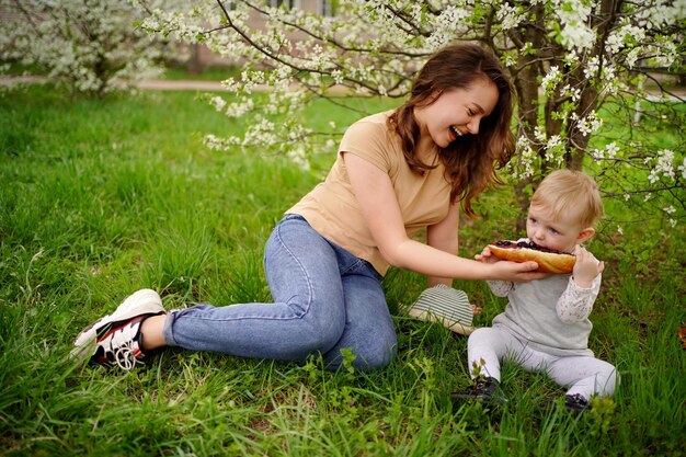 Foto madre e figlia mangiano pane alla marmellata in una sorgente di picnic