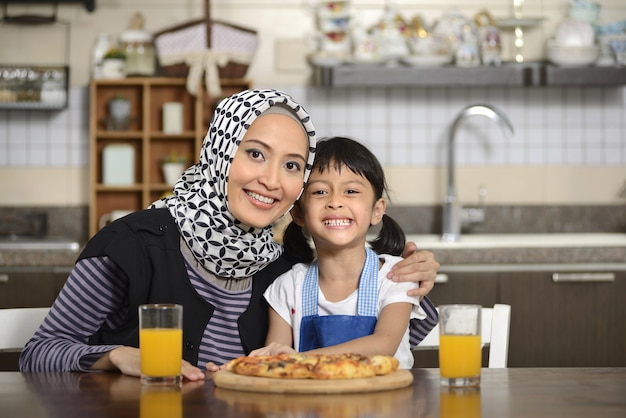 Mother And Daughter Eating Pizza