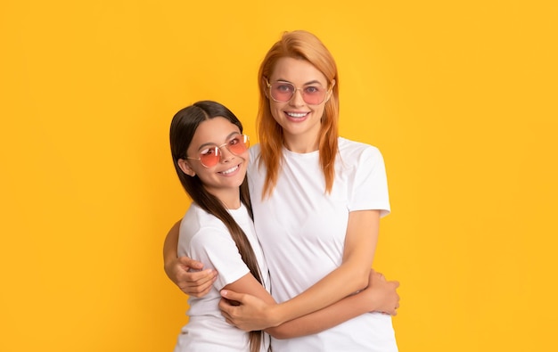 Mother and daughter embrace in sunglasses beauty and fashion female fashion model