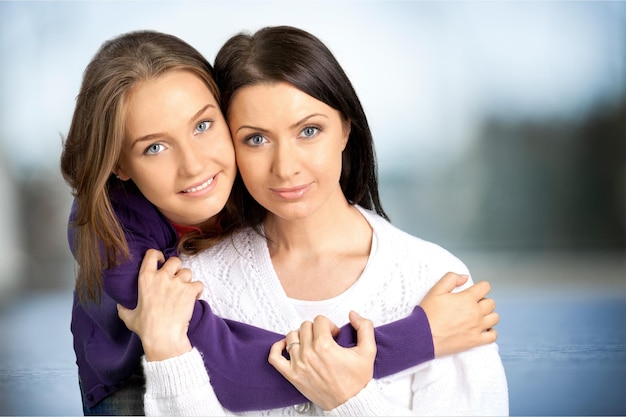 Mother and daughter embracing and smiling