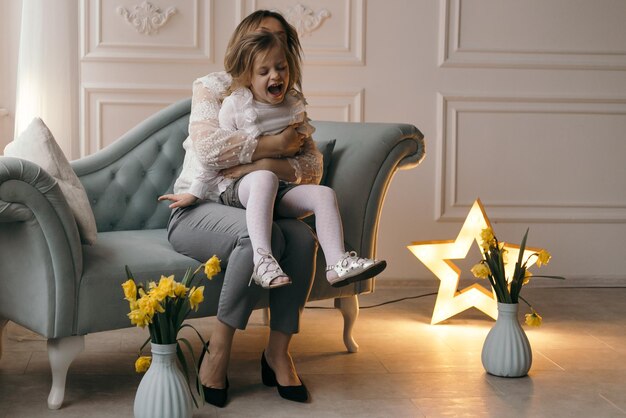 Mother and daughter enjoy at home and looking at camera