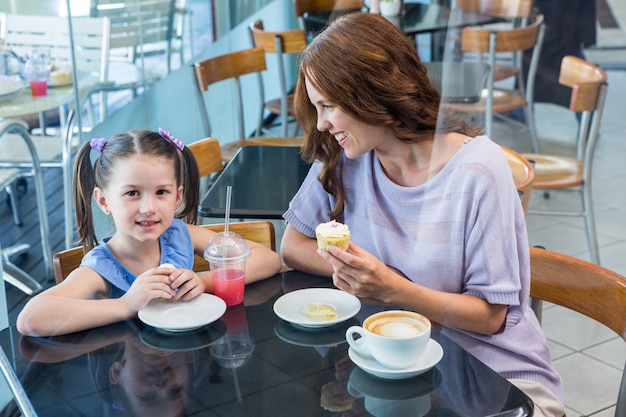 Mother and daughter enjoying cakes