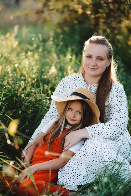 Mother and daughter in the garden looking at the camera