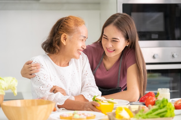 Mother and Daughter happy cooking in kitchen