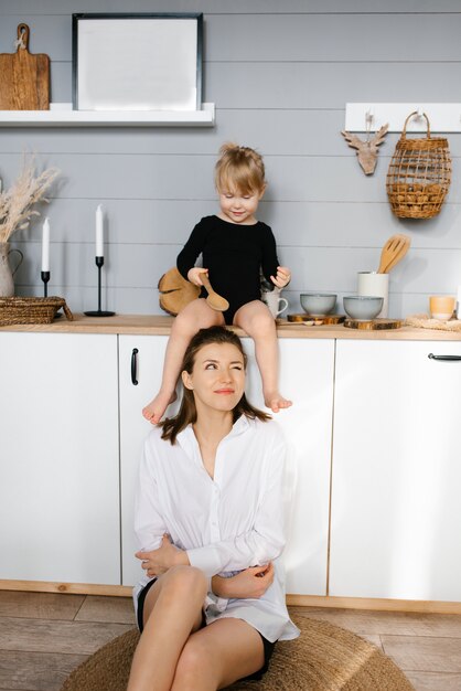 Mother and daughter have fun with wooden spoons