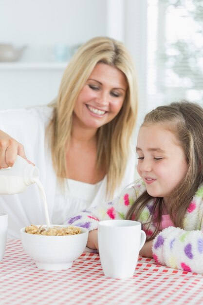 mother and daughter having cereal