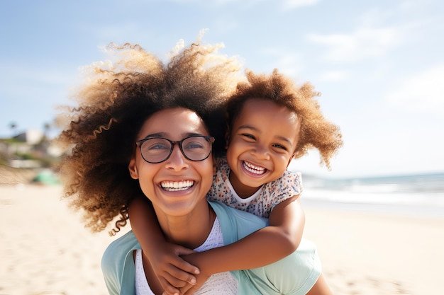 Mother and daughter having fun on the beach Portrait of happy woman giving a piggyback ride to cute little girl Love and parenthood concept