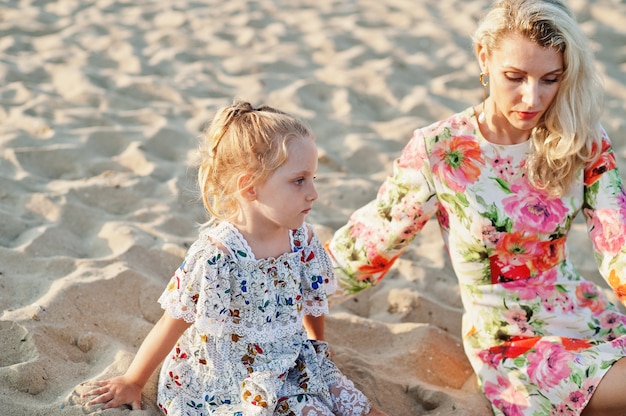 Mother and daughter having fun on the beach