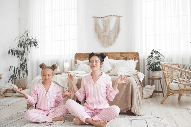 Mother and daughter having fun at home. Girls indoors.