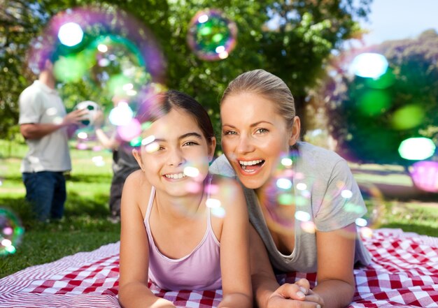 Mother and daughter having fun in the park