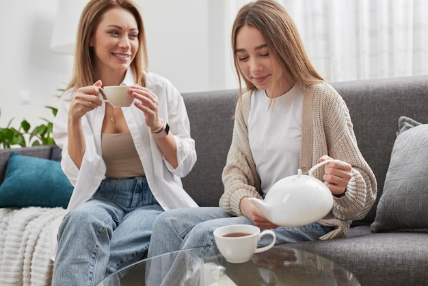 Mother and daughter having teatime together