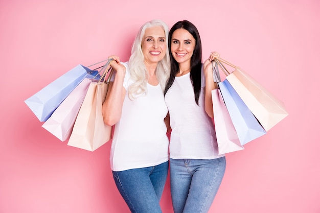 mother and daughter holding shopping bags