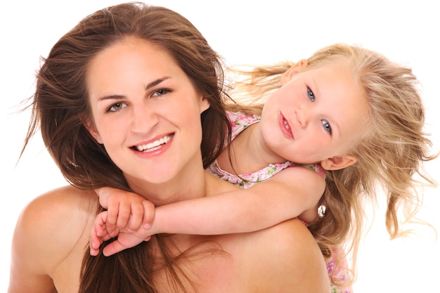 a mother and daughter hugging and smiling over white