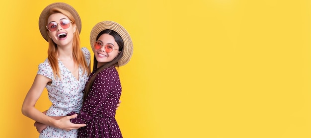 Mother and daughter kid banner copy space isolated background\
positive mother and child in straw hat on yellow background